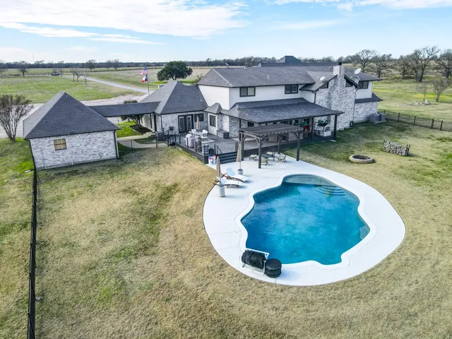 an aerial view of a house with a ocean view