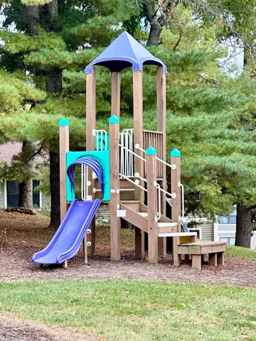 a view of a chairs and table in the backyard