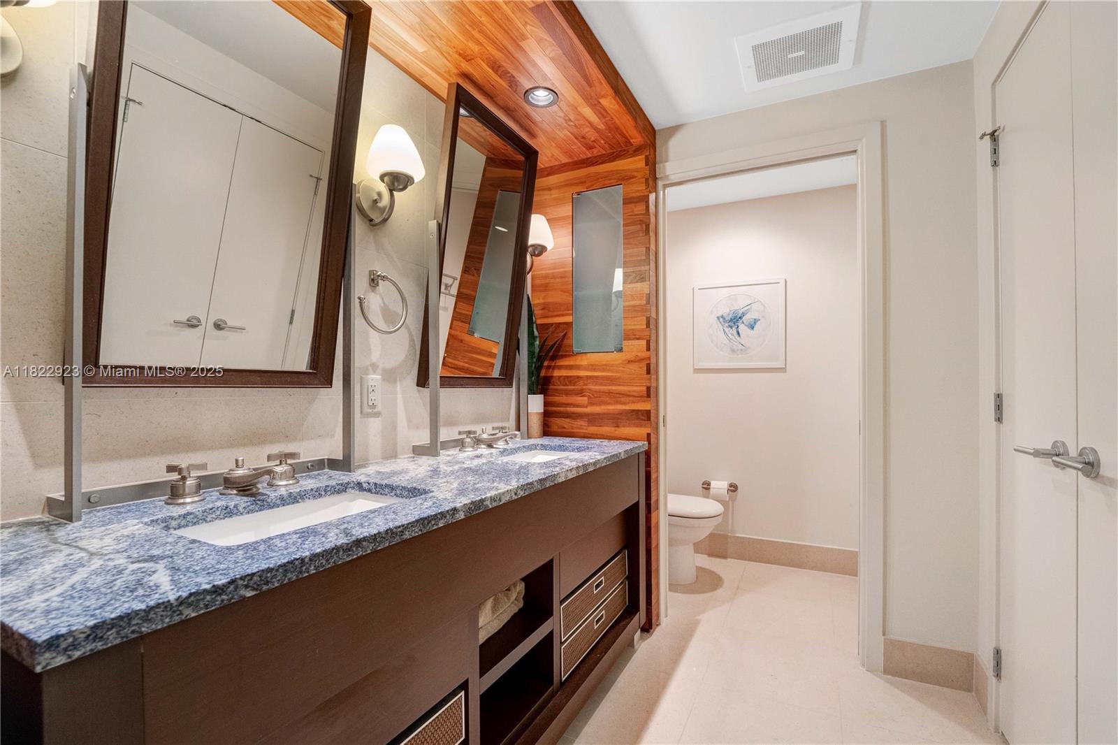 6899 Collins Avenue, Unit 1409 Miami Beach, FL 33141 - Photo 21 of 35 a bathroom with a granite countertop sink and a mirror
