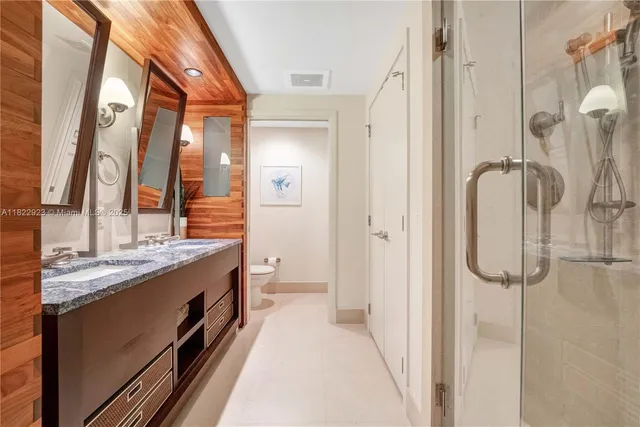a kitchen with granite countertop a refrigerator and wooden floor