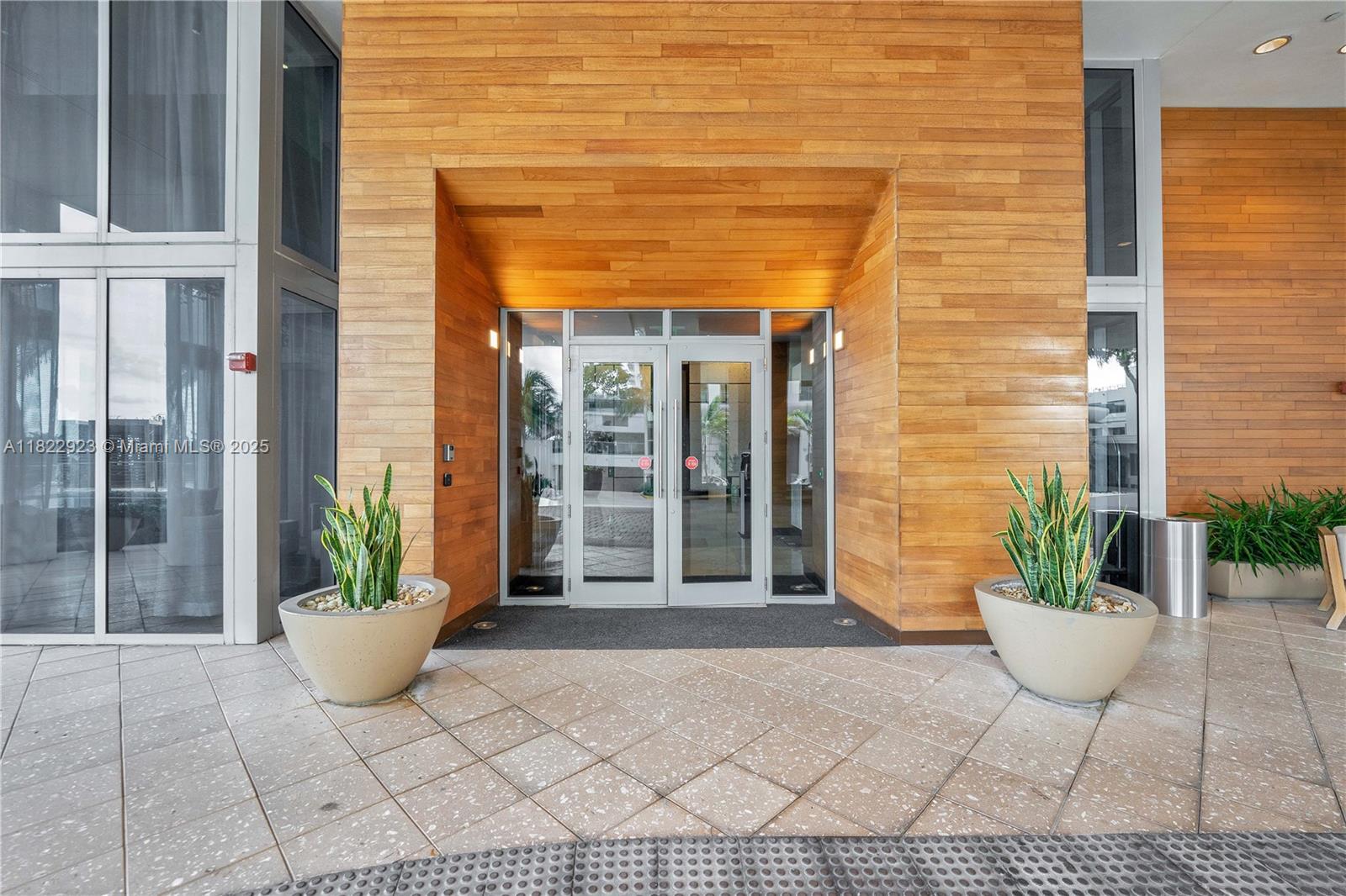 6899 Collins Avenue, Unit 1409 Miami Beach, FL 33141 - Photo 33 of 35 a view of a door of the house with potted plants