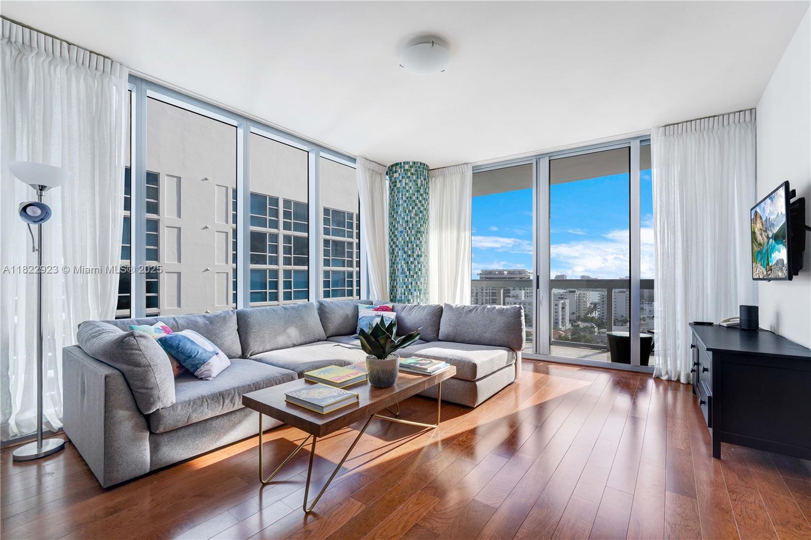 6899 Collins Avenue, Unit 1409 Miami Beach, FL 33141 - Photo 4 of 35 a living room with furniture and a large window