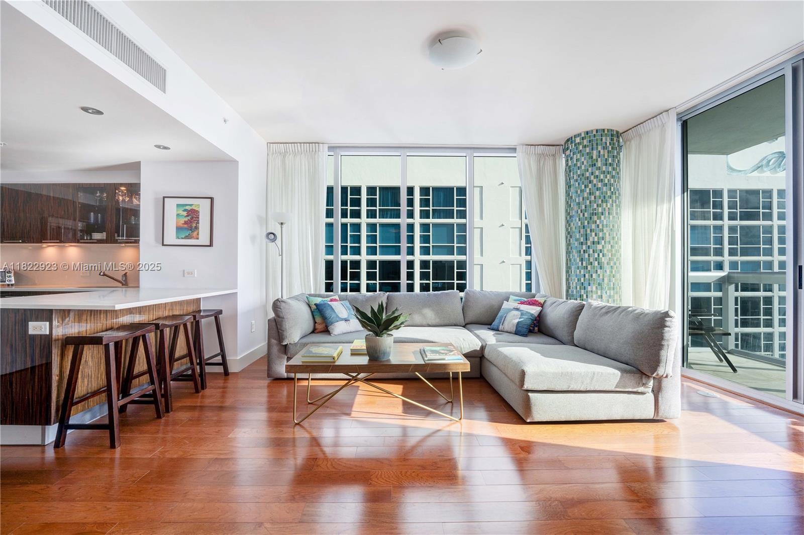 6899 Collins Avenue, Unit 1409 Miami Beach, FL 33141 - Photo 7 of 35 a living room with furniture and a large window