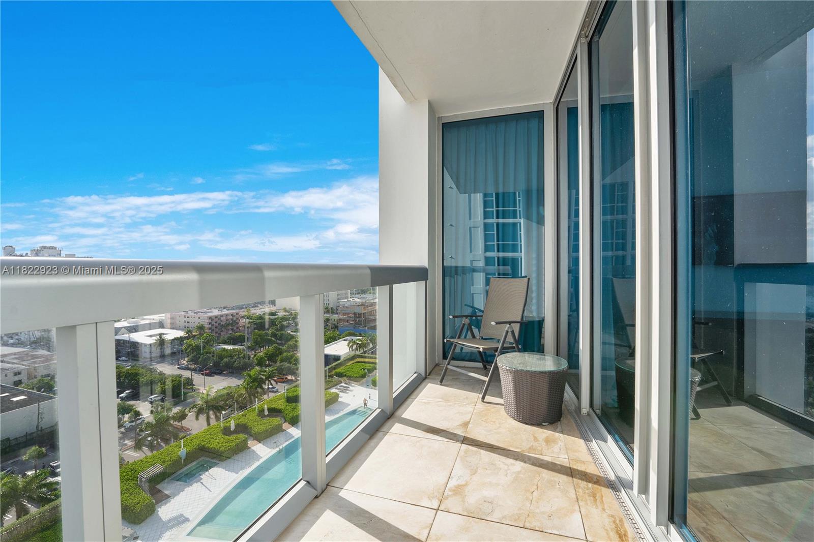 6899 Collins Avenue, Unit 1409 Miami Beach, FL 33141 - Photo 9 of 35 a view of a balcony with a floor to ceiling window and garden
