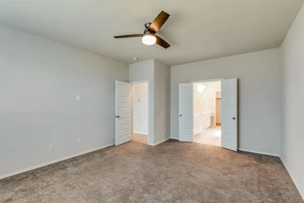an empty room with closet and windows