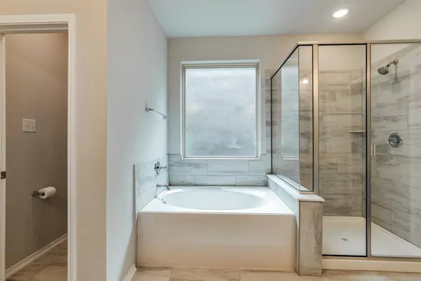 a bathroom with a bathtub and shower