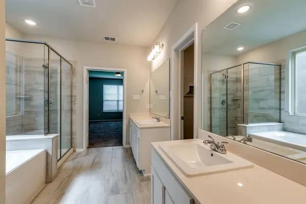 a bathroom with a sink tub shower and a mirror