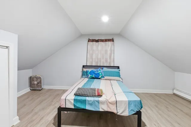 a living room with a couch and wooden floor