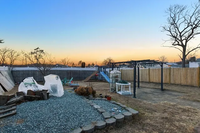 a view of a house with backyard and sitting area