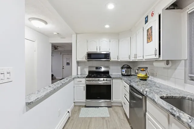 a kitchen with stainless steel appliances granite countertop a stove and a sink