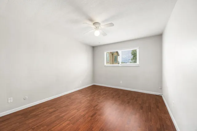wooden floor in an empty room with a window
