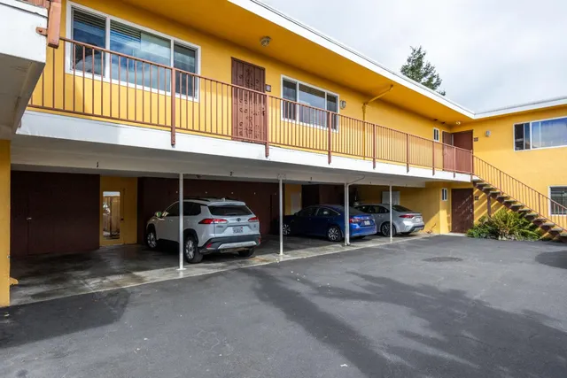a view of a building with car parked