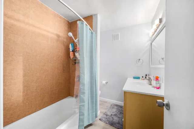 a bathroom with a tub and shower