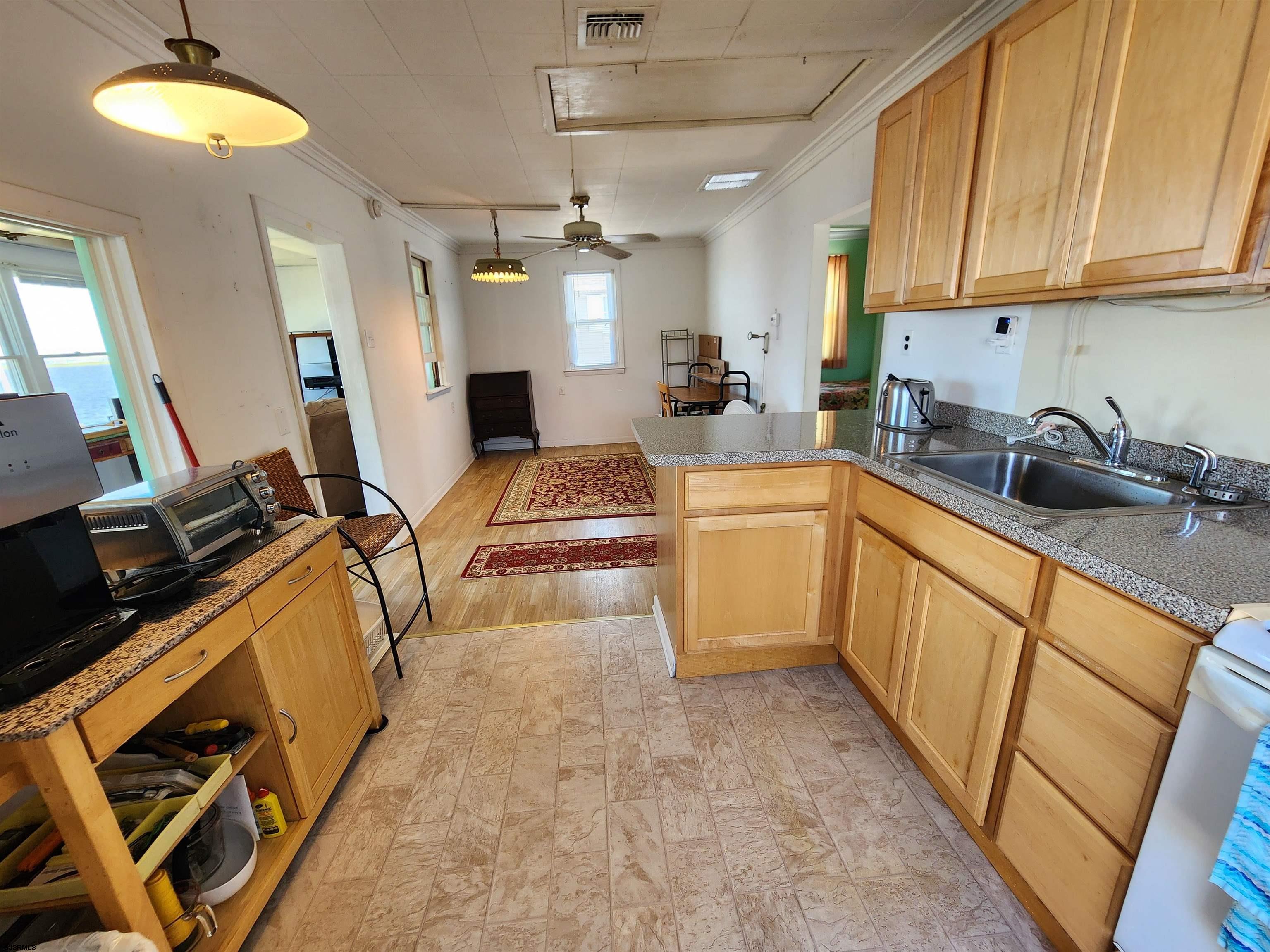 17 River Road Port Republic, NJ 08241 - Photo 7 of 17 a kitchen with a sink stove and cabinets