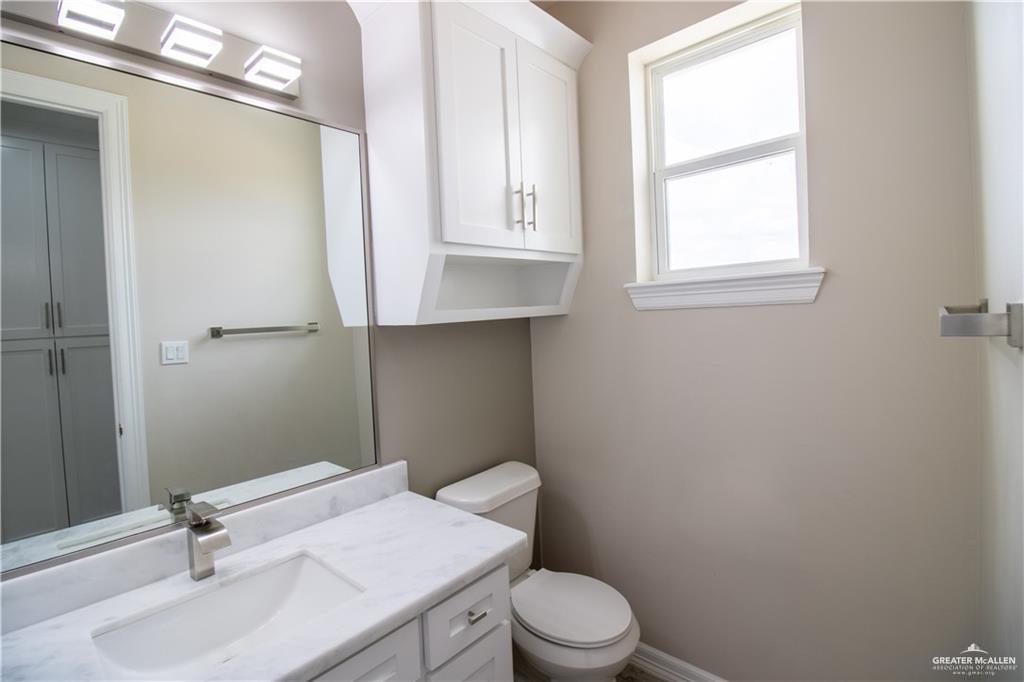 5315 North Crown Point Pharr, TX 78577 - Photo 15 of 30 a bathroom with a sink a toilet and a window