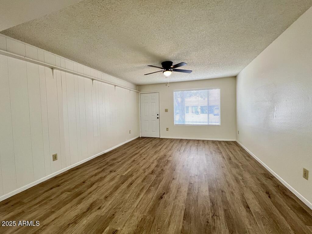 710 East Fordham Drive Tempe, AZ 85283 - Photo 4 of 12 wooden floor in an empty room with a window