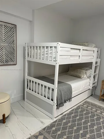 a bedroom with a bed and a chair