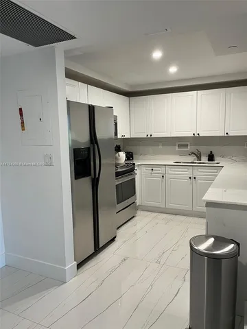 a kitchen with a sink stainless steel appliances and cabinets