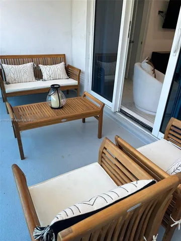 a view of sitting area with furniture and wooden floor