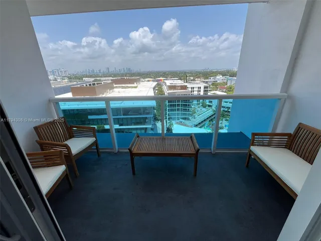 a view of a balcony with chairs and a potted plant