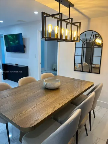 a kitchen view with table and chairs