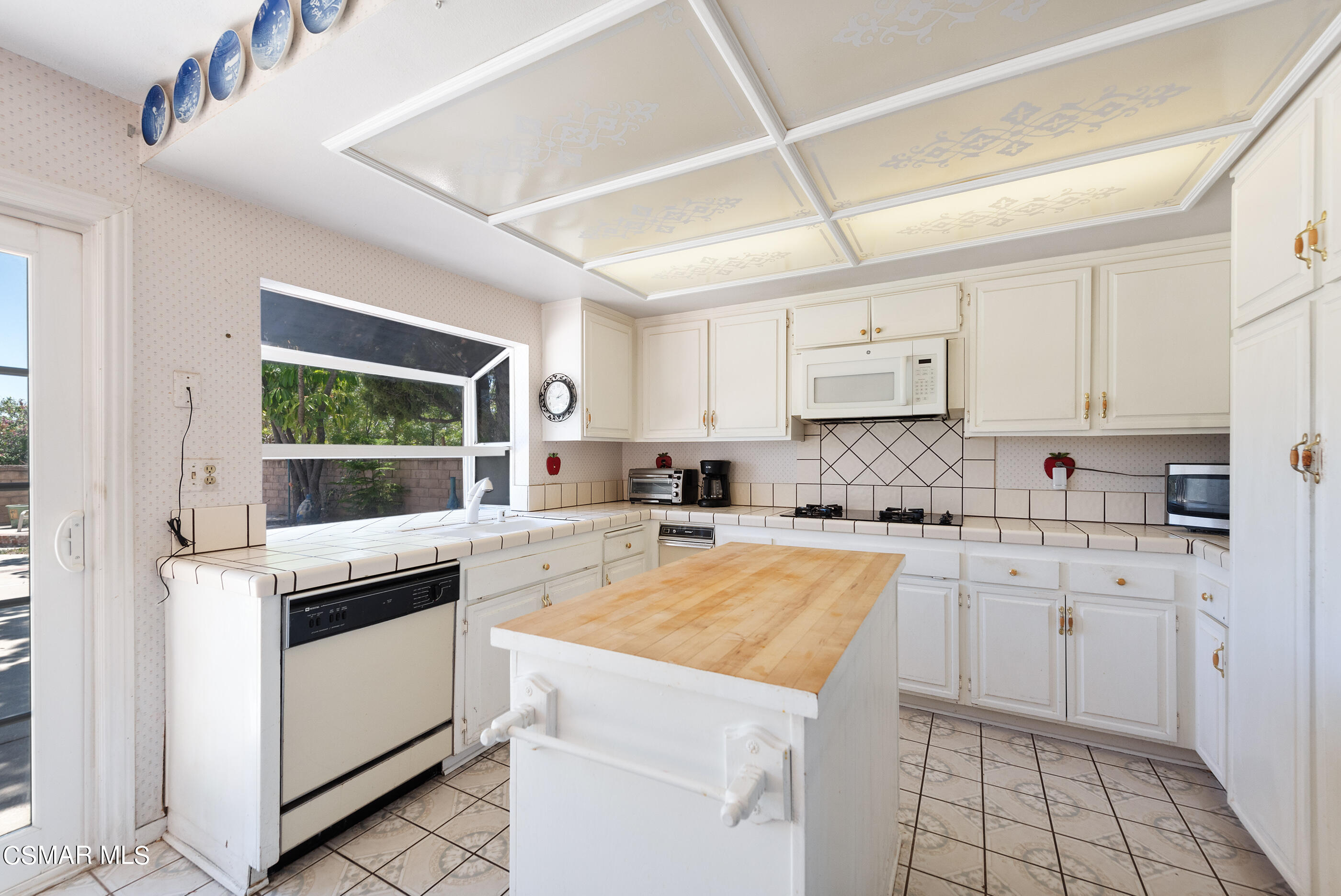 4230 Roxbury Street Simi Valley, CA 93063 - Photo 13 of 40 a kitchen with a stove a sink and white cabinets