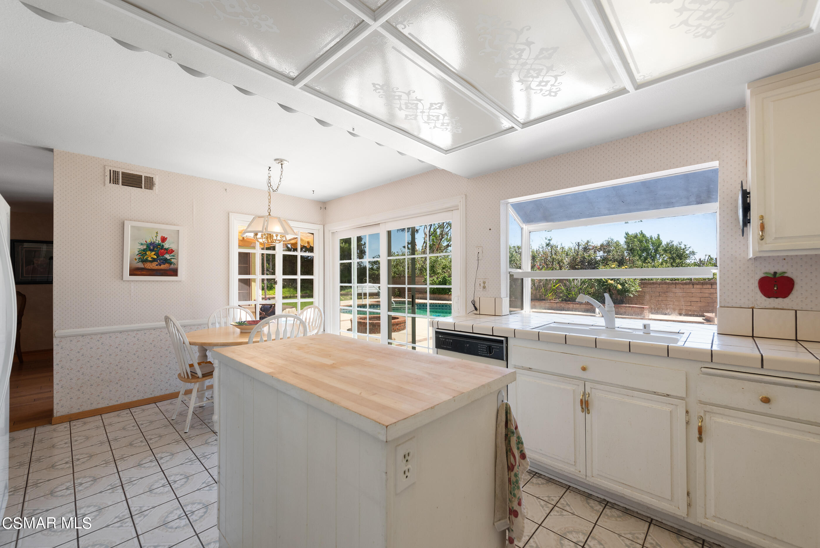 4230 Roxbury Street Simi Valley, CA 93063 - Photo 17 of 40 a kitchen with a stove a sink a refrigerator and window