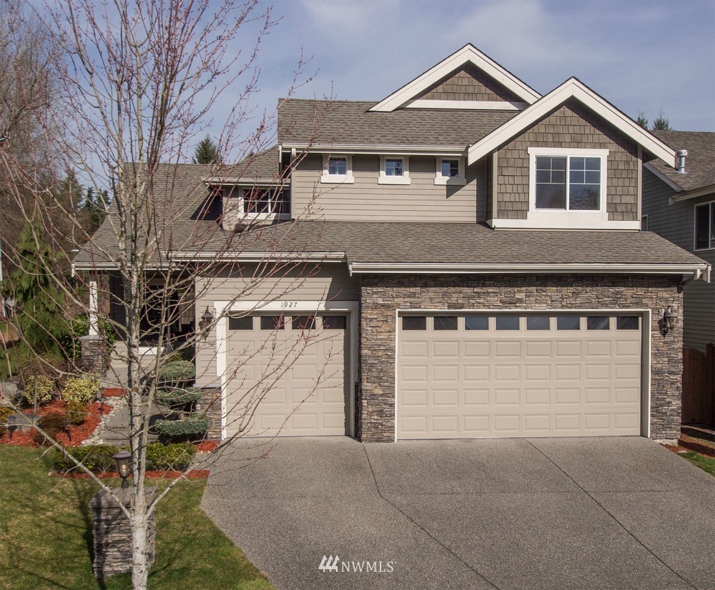 1927 235th Place Southwest Bothell, WA 98021 - Photo 1 of 1 a front view of a house with a yard and garage