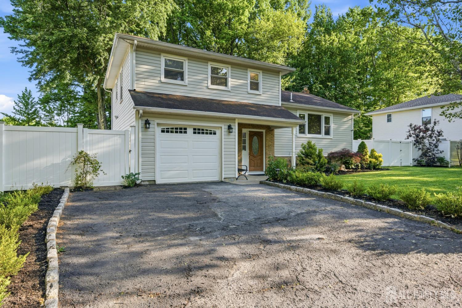 5 McKinley Street Edison, NJ 08820 - Photo 2 of 38 a front view of a house with a yard and a garage