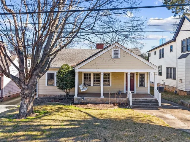 a view of a house with swimming pool and sitting area