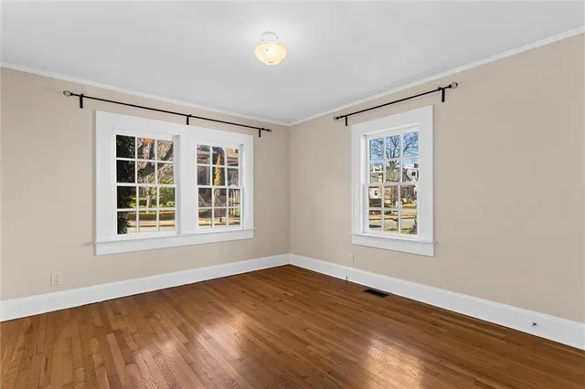 an empty room with wooden floor