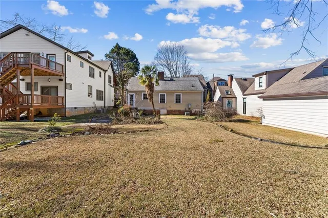 a front view of a house with a yard and outdoor seating
