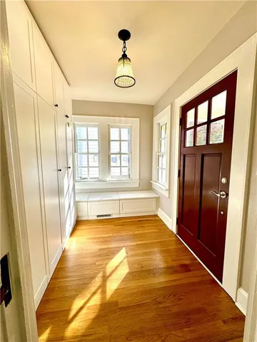 a view of an entryway with wooden floor