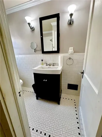 a bathroom with a sink a mirror and vanity