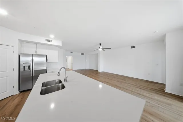 a kitchen with stainless steel appliances a refrigerator and a sink