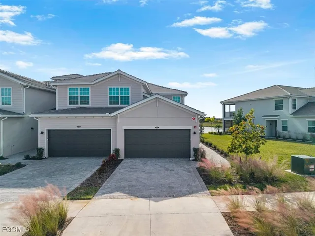 a front view of a house with a yard and garage