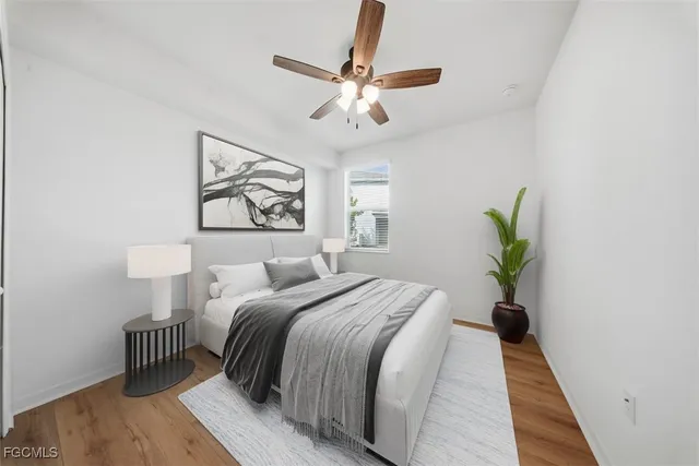 a bedroom with a bed and a painting on the wall