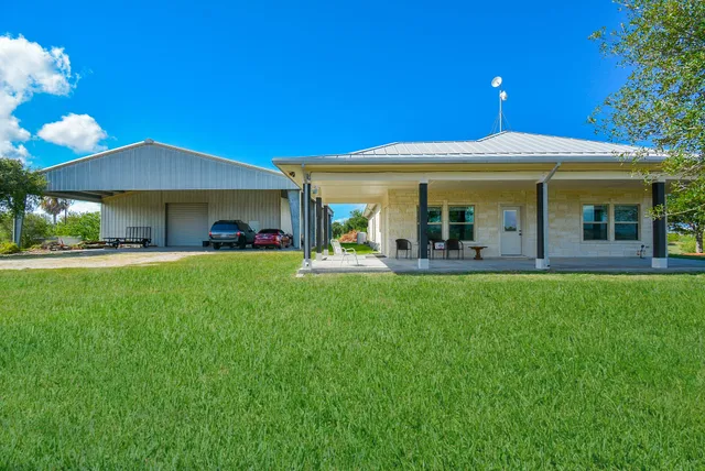 a front view of house with yard and outdoor seating
