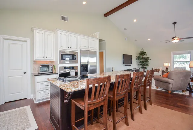 a large kitchen with a table and chairs