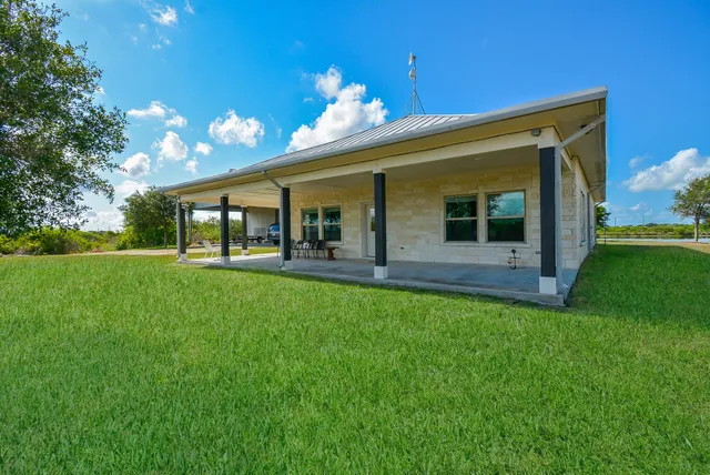 a front view of house with yard and outdoor seating