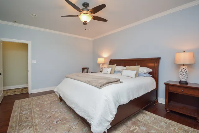 a bedroom with a bed and a lamp on dresser