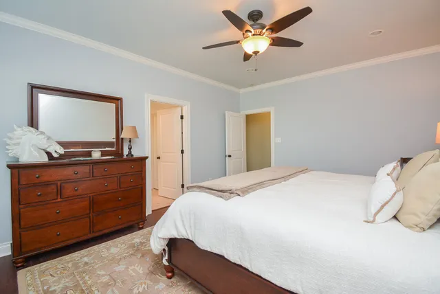 a bedroom with a bed and a mirror on dresser