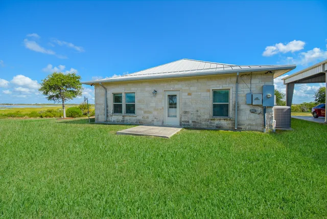 a front view of house with yard and outdoor seating