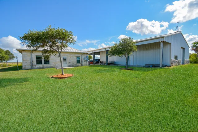 a front view of house with a garden