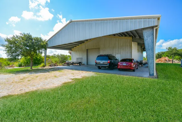a car parked in front of a house with a yard