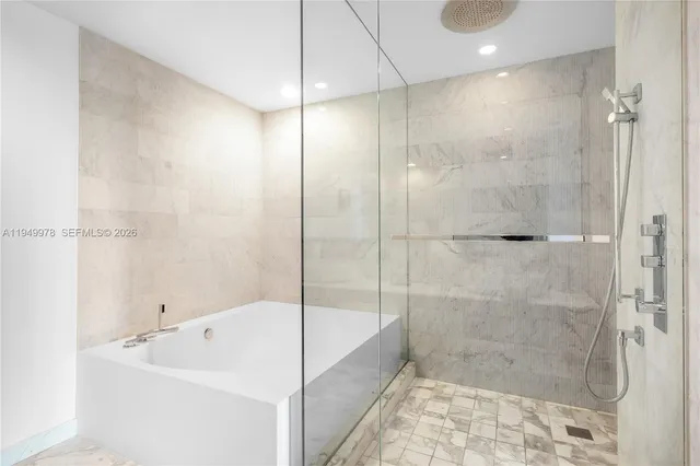 a bathroom with a bathtub and shower