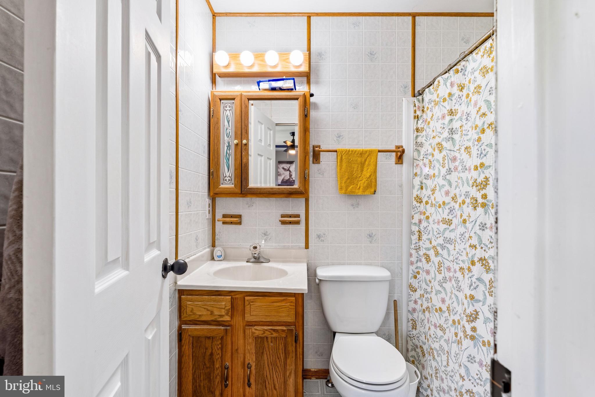 8 Anchor Court Perryville, MD 21903 - Photo 12 of 18 a bathroom with a toilet sink and mirror