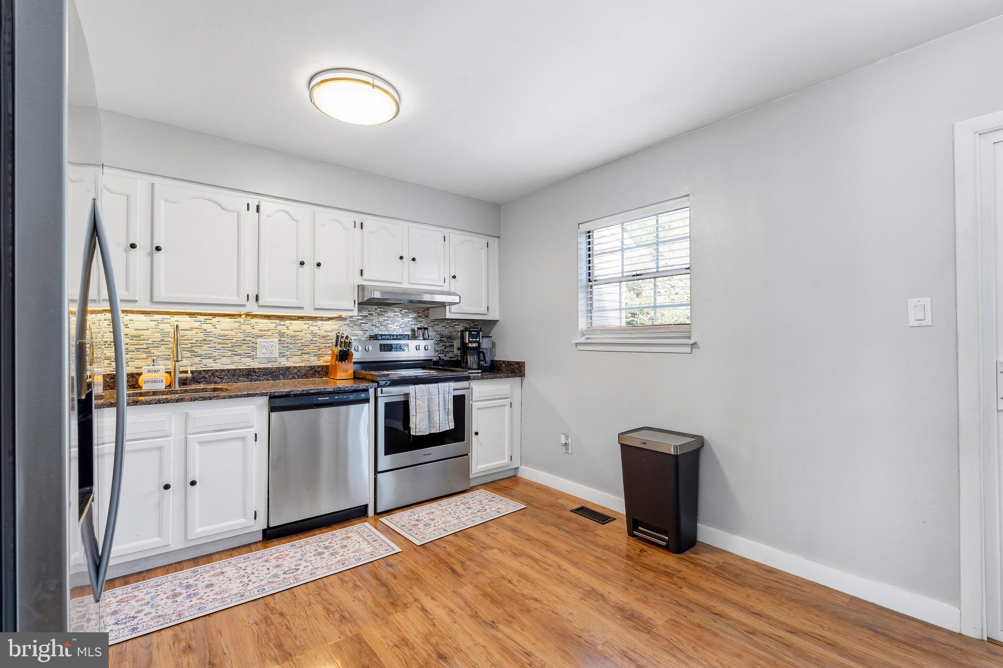 8 Anchor Court Perryville, MD 21903 - Photo 5 of 18 a kitchen with granite countertop a stove cabinets and wooden floor