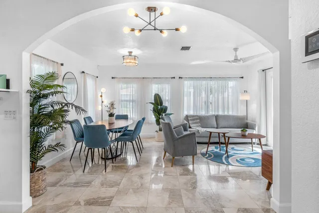 a living room with furniture and a potted plant