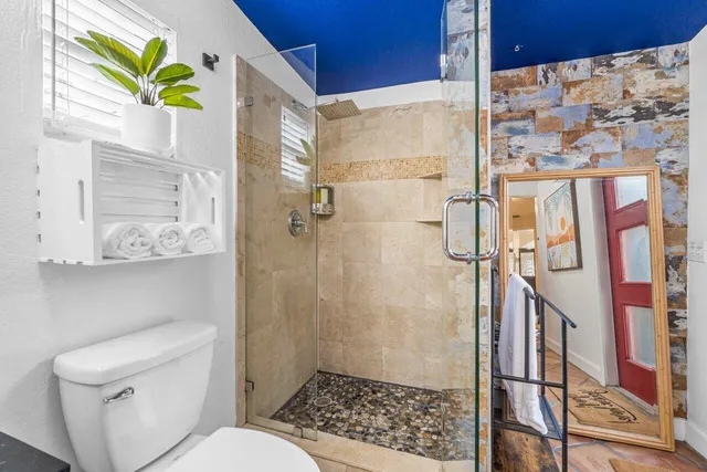 a wooden bench sitting in front of a building